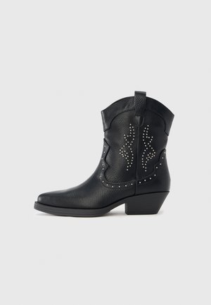 Black cowboy boot with silver studs, textured leather, pointed toe, and slightly elevated heel. Design features decorative stitching.