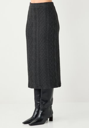Gray textured wool midi skirt with a straight cut, featuring a high waistband and paired with black pointed-toe knee-high boots.