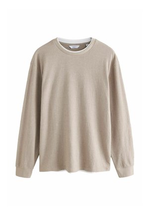 Chemise beige à manches longues avec texture côtelée, col rond et poignets clairs contrastants. Fabriquée dans un tissu doux et léger.