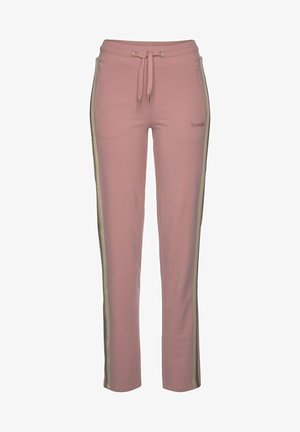 Pink sweatpants made of soft fabric, featuring a drawstring waist, side pockets, and metallic gold stripes along the sides.