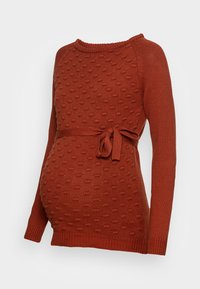 Rostfärgad gravidtröja i texturerad tyg med rundad halsringning och långa ärmar. Har en knytning vid midjan som accent.