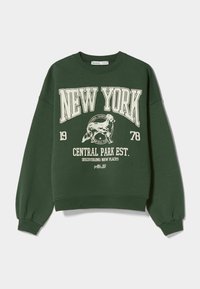 Tmavě zelená mikina s kulatým výstřihem. Obsahuje bílý text "NEW YORK" a grafiku psa. Žebrované manžety a lem, volný střih.