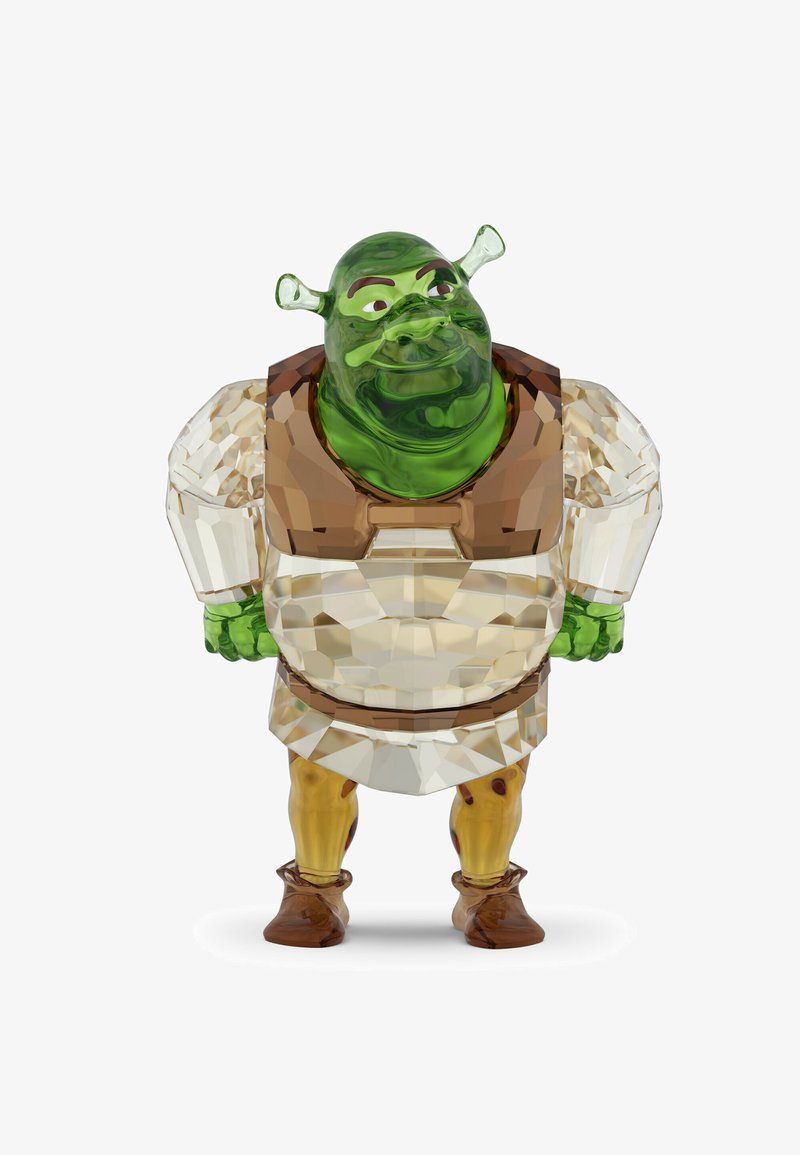 Figurine d'un ogre vert portant une tunique blanche et un gilet marron, en verre translucide et coloré à facettes.