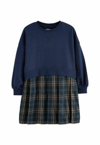 Mörkblå sweatshirt med ribbad halsringning, kombinerad med en rutig plisserad kjol i mörkgrön, brun och beige. Långärmade med manschetter.