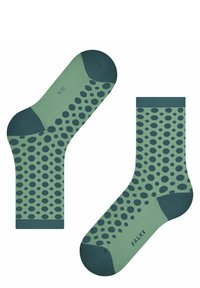 Grüne Socken mit dunkelgrünen Punkten. Verstärkte Zehen und Fersen. Mit gerippten Bündchen und einer weichen Textur. Markennamen auf der Sohle gedruckt.