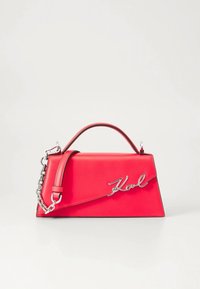 Red leather handbag with a structured design, featuring a top handle, chain strap, and silver "Karl" logo on the front.