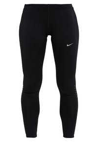 Black athletic leggings made of stretchy fabric, featuring a fitted design, a small silver Nike logo, and reflective accents near the ankles.
