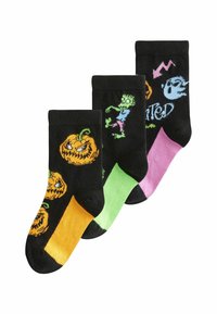 Sorte sokker med Halloween-designs: orange græskar, en grøn zombie og et spøgelse, med livlige farver i grøn, pink og orange.