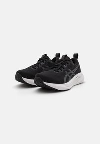 Black athletic shoes with a mesh upper, contrasting white midsole, textured black outsole, and reflective detailing on the sides.