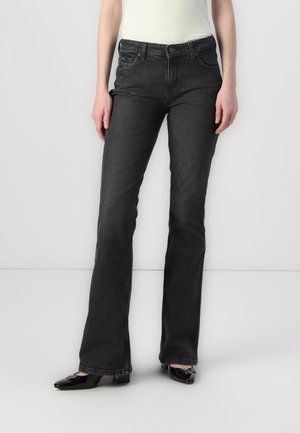 Black flared denim jeans with a smooth texture, five-pocket design, and a front button closure, paired with glossy black shoes.