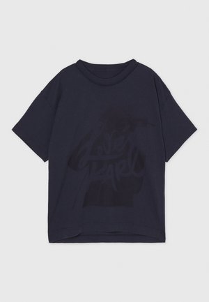 Black cotton oversized t-shirt with short sleeves, featuring a subtle graphic design in darker shades of black on the front.