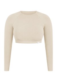 Crop top long à manches longues de couleur beige clair, fabriqué en tissu doux, avec un col rond et des manches raglan, doté d'un ourlet ajusté.