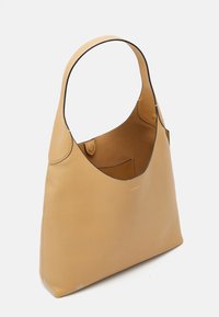 Sac à épaule en cuir marron avec une large bandoulière unique, ouverture supérieure dévoilant une poche intérieure, et petit logo de marque embossé.