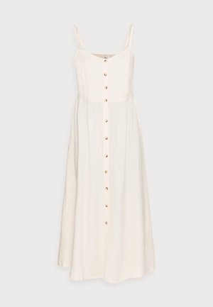 Vestido de lino color beige claro con tirantes finos, un frente abotonado y una falda fluida. Presenta un diseño sencillo y una textura natural.