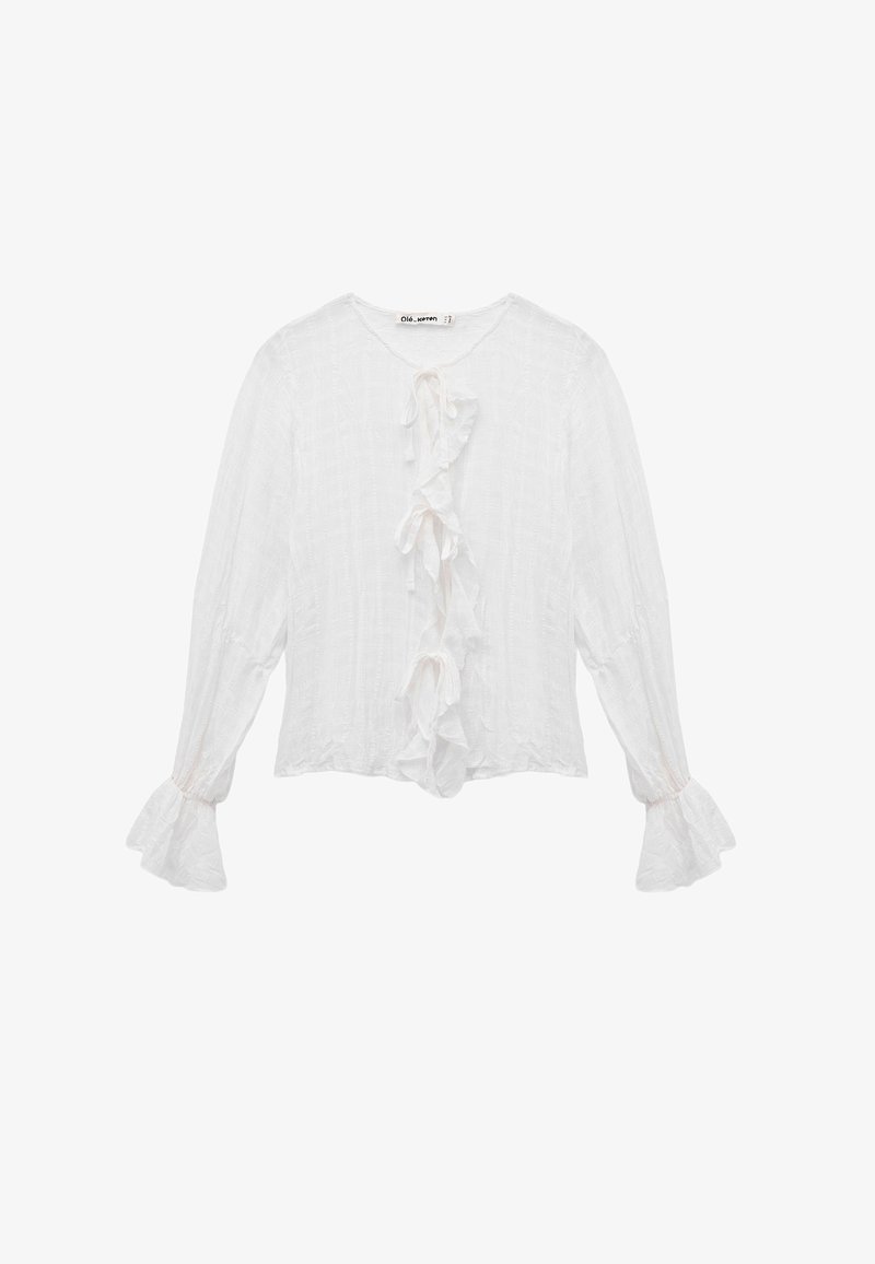 Weiße Bluse mit langen Ärmeln aus strukturiertem Stoff, mit einem zentralen Rüschendetail und ausgestellten Manschetten. Mit Bindeband am Ausschnitt.