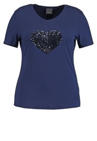 Navy blue short-sleeve T-shirt with a large black sequined heart design centered on the chest.