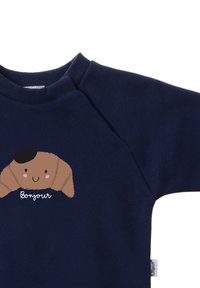 Navy blue sweatshirt with a round neckline. Features a cartoon croissant graphic with a hat and the text "Bonjour" in white. Soft texture.