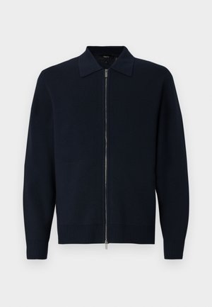 Granatowy sweter z dzianiny z zapięciem na zamek, strukturalnym kołnierzem, prążkowanymi mankietami i dołem. Miękka tekstura oraz elegancki, nowoczesny design.