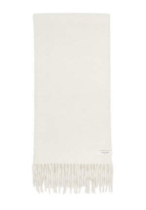 Soft cream-colored scarf with twisted fringe edges and a small white label reading comma est. 1973 on one corner.
