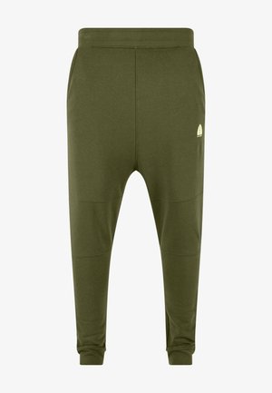 Pantalon de jogging fuselé vert olive avec taille élastique, poches latérales, coutures aux genoux, poignets aux chevilles et petit logo feuille blanche sur la cuisse droite.
