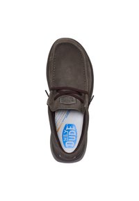 Zapato de ante marrón con punta redonda, cordones y plantilla acolchada que presenta un logotipo azul claro. Detalles de costura a lo largo del borde.