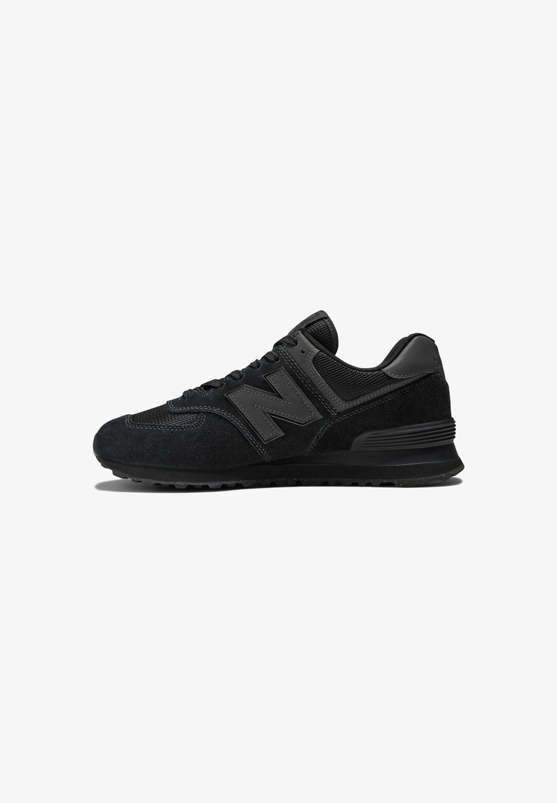 Black sneaker featuring a suede and mesh upper, thick sole, and prominent 'N' logo on the side. Textured design with lace closure.