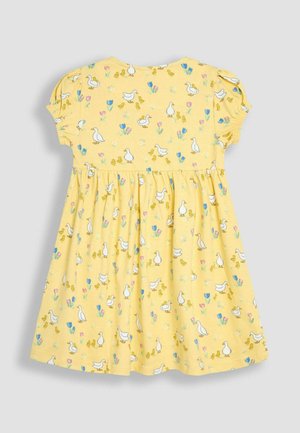 Sárga, rövid ujjú ruha, kacsák és virágok mintájával. Puha anyagból készült, rakott szoknyával a bőségért.