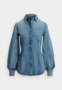 Ljusblå denimskjorta med spetsig krage, puffärmar och sidofickor. Har en knappstängning och en rundad nederkant.