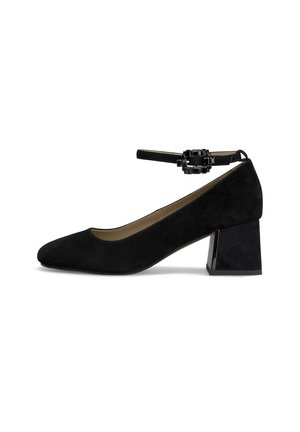 Black suede block-heel shoe with a rounded toe, ankle strap featuring a decorative buckle, and a textured surface.