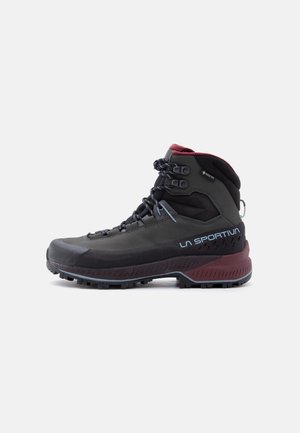 High-top black and burgundy hiking boot with rugged sole, lace-up front, Gore-Tex label, and La Sportiva branding on the side.