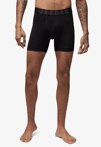 Boxer shorts noirs en coton doux. Dotés d'une large ceinture avec le logo "JORDAN". Design ajusté avec une texture lisse.