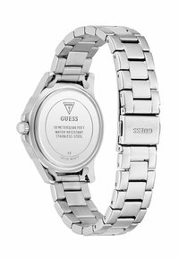 Montre-bracelet en acier inoxydable argenté avec un design à maillons et un boîtier rond. Le dos présente le logo de la marque et des détails sur la résistance à l'eau.