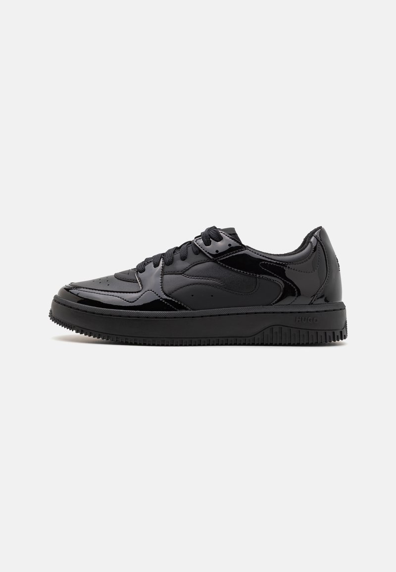 Fekete sneaker, sima, fényes lakkbőr felsőrésszel, perforált részlettel az orrán és texturált talppal a tapadásért. Minimalista dizájn.