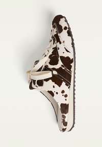 Footwear featuring a brown and white cowhide pattern, with a textured upper, lace-up closure, and a flexible rubber sole.