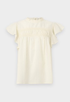 Krém színű blúz fodros rövid ujjal, magas fodros nyakkivágással és csipkedíszítéssel a mellrészen.