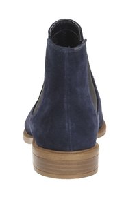 Marinblå mocka ankelskor med elastiska sidopaneler, rund tå och en staplad brun klack. Slät yta med en minimalistisk design.