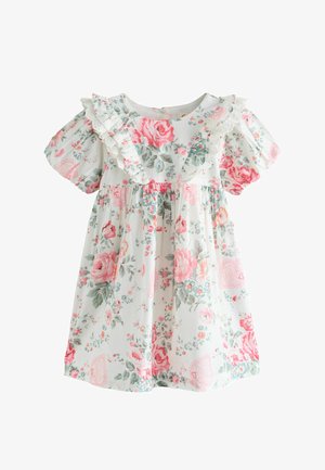Weißes Baby-Kleid mit rosa und grünem Blumenmuster, Puffärmeln und gerafftem Spitzenbesatz an Brust und Schultern.