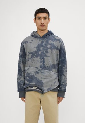 Gray and blue tie-dye hoodie with a V-neck, long sleeves, and kangaroo pocket. Features a curved hem and ribbed cuffs and waistband.