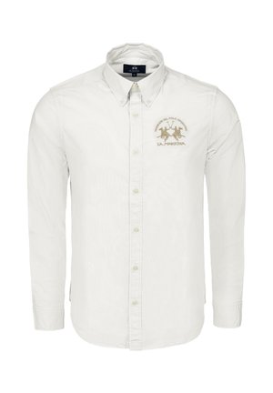 Biała koszula na guziki wykonana z bawełny. Posiada szpiczasty kołnierzyk, długie rękawy oraz złote haftowane logo na lewej piersi.