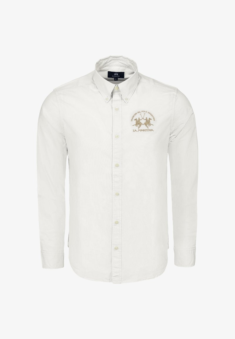 Bílá košile na knoflíky z bavlny. Má špičatý límec, dlouhé rukávy a zlatě vyšívané logo na levé straně hrudi.