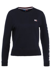 Felpa blu navy in cotone, con scollatura rotonda, polsini a coste e un'etichetta con logo sul petto, con testo bianco lungo la manica.