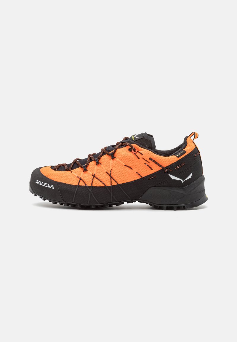 Orange and black hiking shoes feature a textured upper, reinforced toe cap, and rubber outsole with a patterned tread for traction.