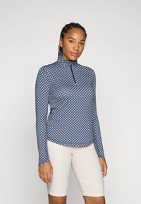 Langarmshirt mit geometrischem Navy-Druck und pinken Akzenten, hohem Kragen und einem Reißverschluss, gefertigt aus elastischem Material.