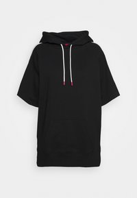 Sort kortærmet hættetrøje med kangurulomme foran og hvide snore med røde ender på en ensfarvet baggrund.