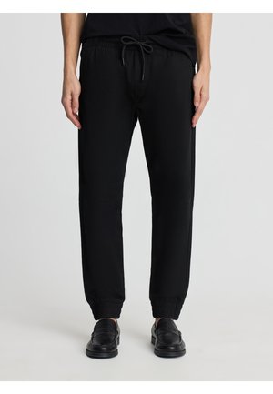 LUNGO TINTA UNITA - Pantaloni - nero