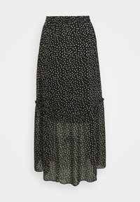 Svart kjol med ett genomskinligt överdrag, prydd med ett prickigt mönster i beige. Elastisk midja, flerlagrad volangdesign och svävande silhuett.