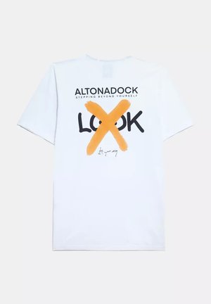 Camiseta de algodón blanca con un diseño gráfico que presenta la palabra "LOOK" tachada en naranja, acompañada del logo de la marca y una firma.