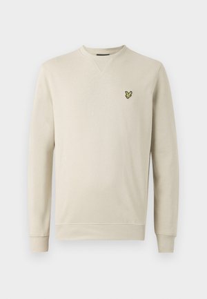 Beige sweatshirt lavet af blødt stof, med lange ærmer, en rund hals og et grønt og gult sommerfuglelogo broderet på brystet.