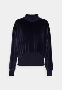 Pull en velours bleu marine avec col montant, épaules tombantes et poignets en côtes. Design court avec une texture lisse et sans motifs visibles.