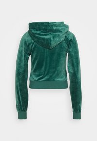 Felpa verde in velluto con un motivo testurizzato sulla cappuccio, polsini e orlo. Caratterizzata da un taglio corto e una vestibilità rilassata.